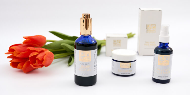 FLat lay of products for Atlantis Skincare - Tulips in the background